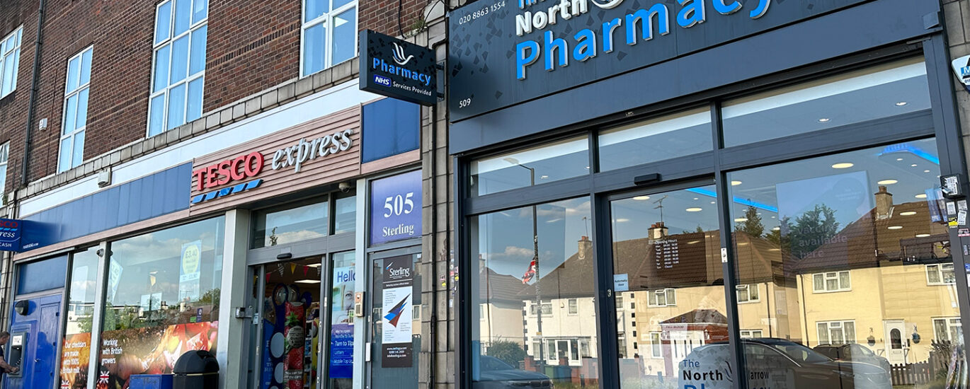 The front view of North Harrow Pharmacy, a welcoming and well-maintained establishment with a prominent sign displaying the pharmacy's name. The entrance is accessible, and the storefront features large windows and a clean exterior, inviting customers to visit the pharmacy