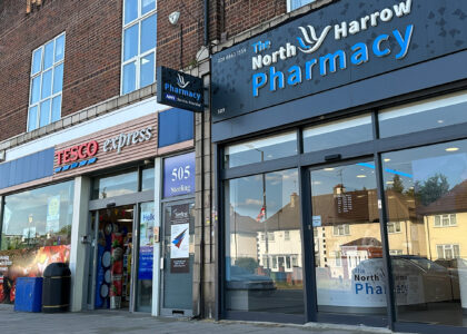 The front view of North Harrow Pharmacy, a welcoming and well-maintained establishment with a prominent sign displaying the pharmacy's name. The entrance is accessible, and the storefront features large windows and a clean exterior, inviting customers to visit the pharmacy