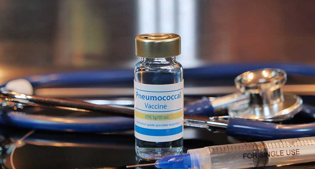 A close-up photo of a vial containing a pneumonia vaccine. The vial is labeled with the name of the vaccine, dosage information, and other relevant details. The image illustrates the packaging of the pneumonia vaccine, emphasizing its role in preventing pneumonia-related illnesses.