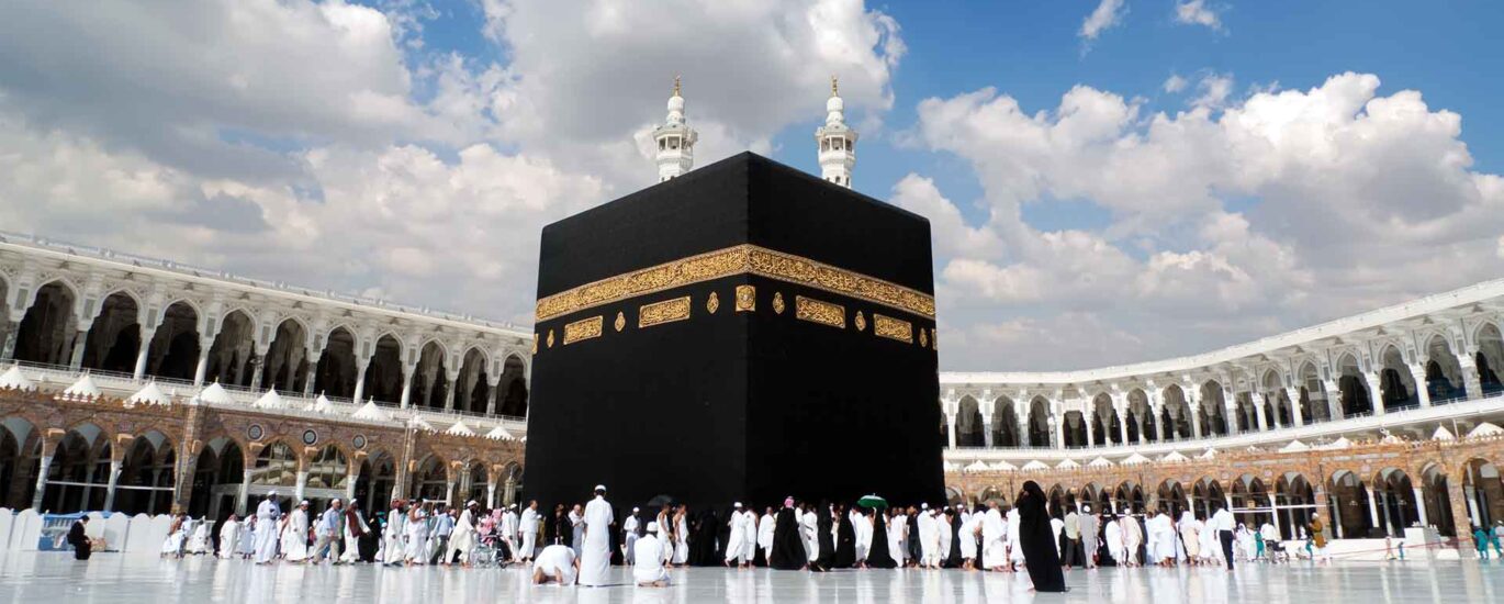 The Kaaba, the holiest site in Islam, is a large black cube-shaped structure draped in a black and gold cloth. Pilgrims from around the world gather around it during Hajj and Umrah, circling it in a counterclockwise direction as part of their religious rituals.