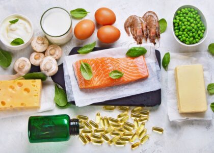 An assortment of foods rich in vitamin D, including fatty fish such as salmon, mackerel, and sardines, fortified dairy products like milk and yogurt, egg yolks, and mushrooms. These foods are excellent dietary sources of vitamin D, which contributes to overall health and well-being.